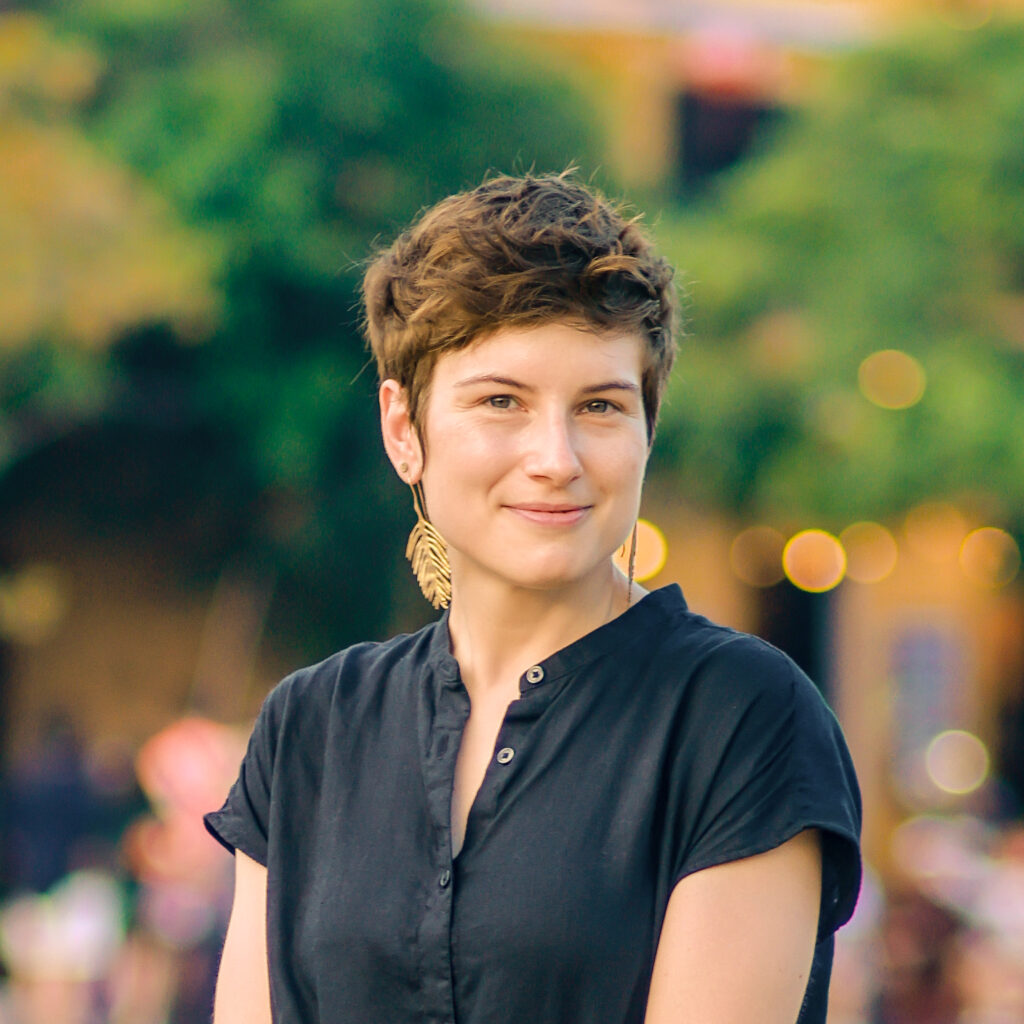 Portrait of Megan Scott, wearing a black dress.