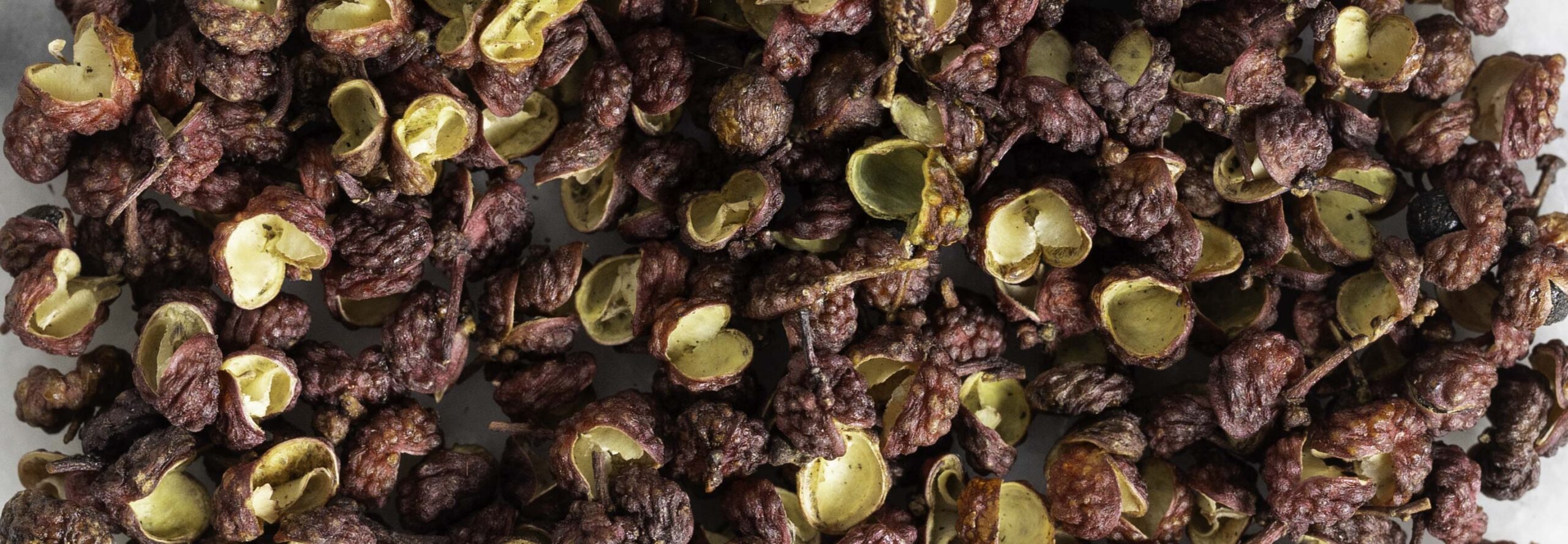 Macro view of red Sichuan pepper.